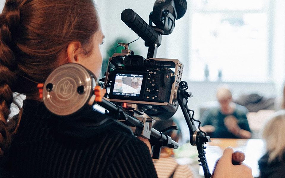 A woman shooting a film with a camera
