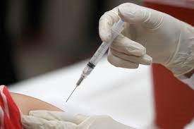 Healthcare worker administering a vaccine.