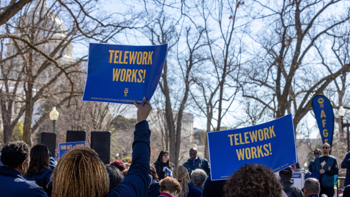 people holding banners of telework works